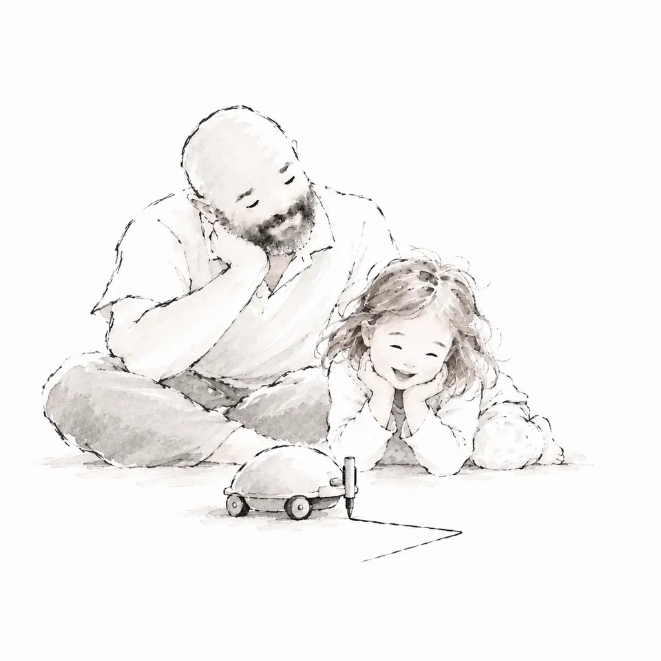 Un padre e una bambina sdraiati sul pavimento guardano un piccolo robot che disegna una linea